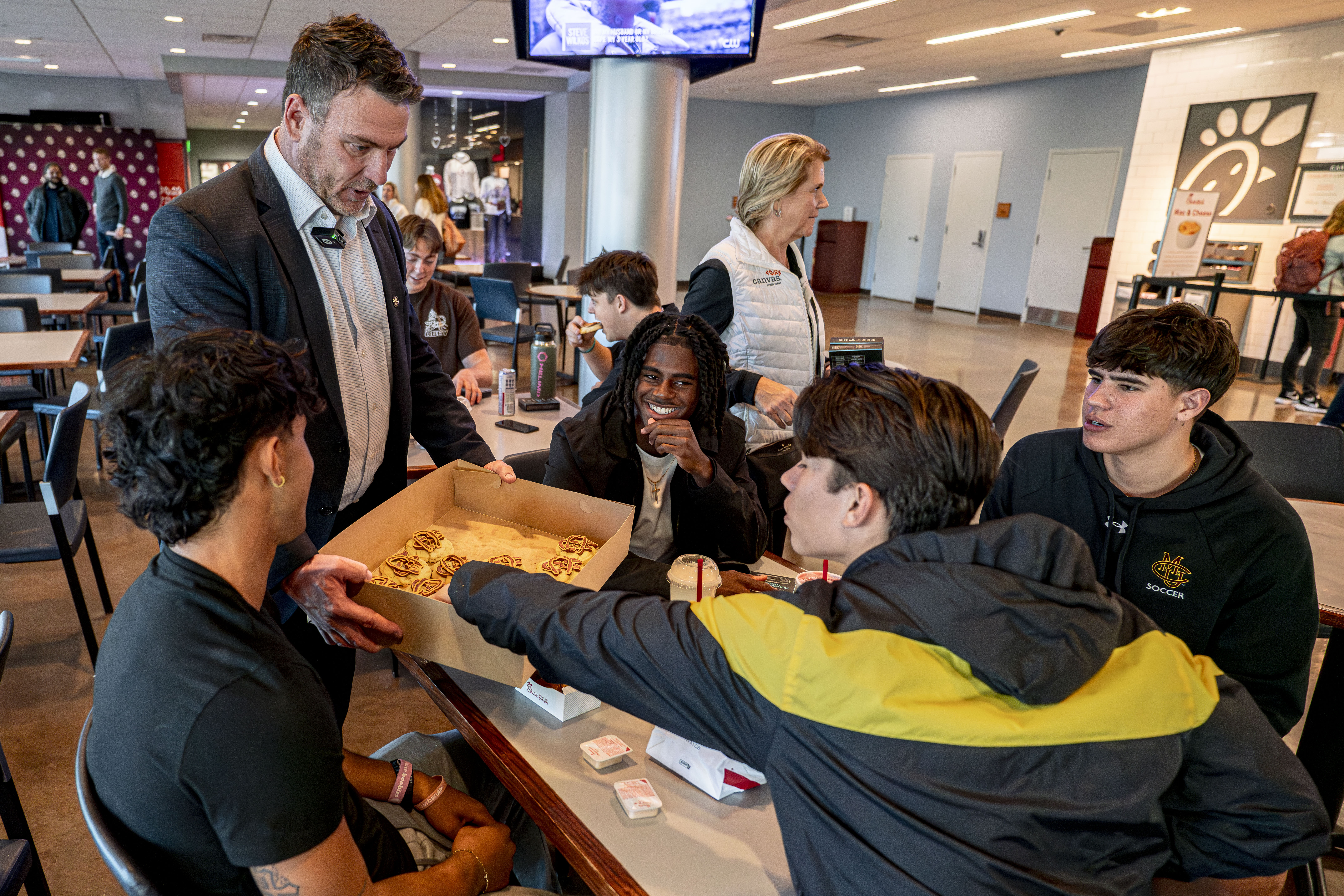 Canvas handing out cookies to students after press conference