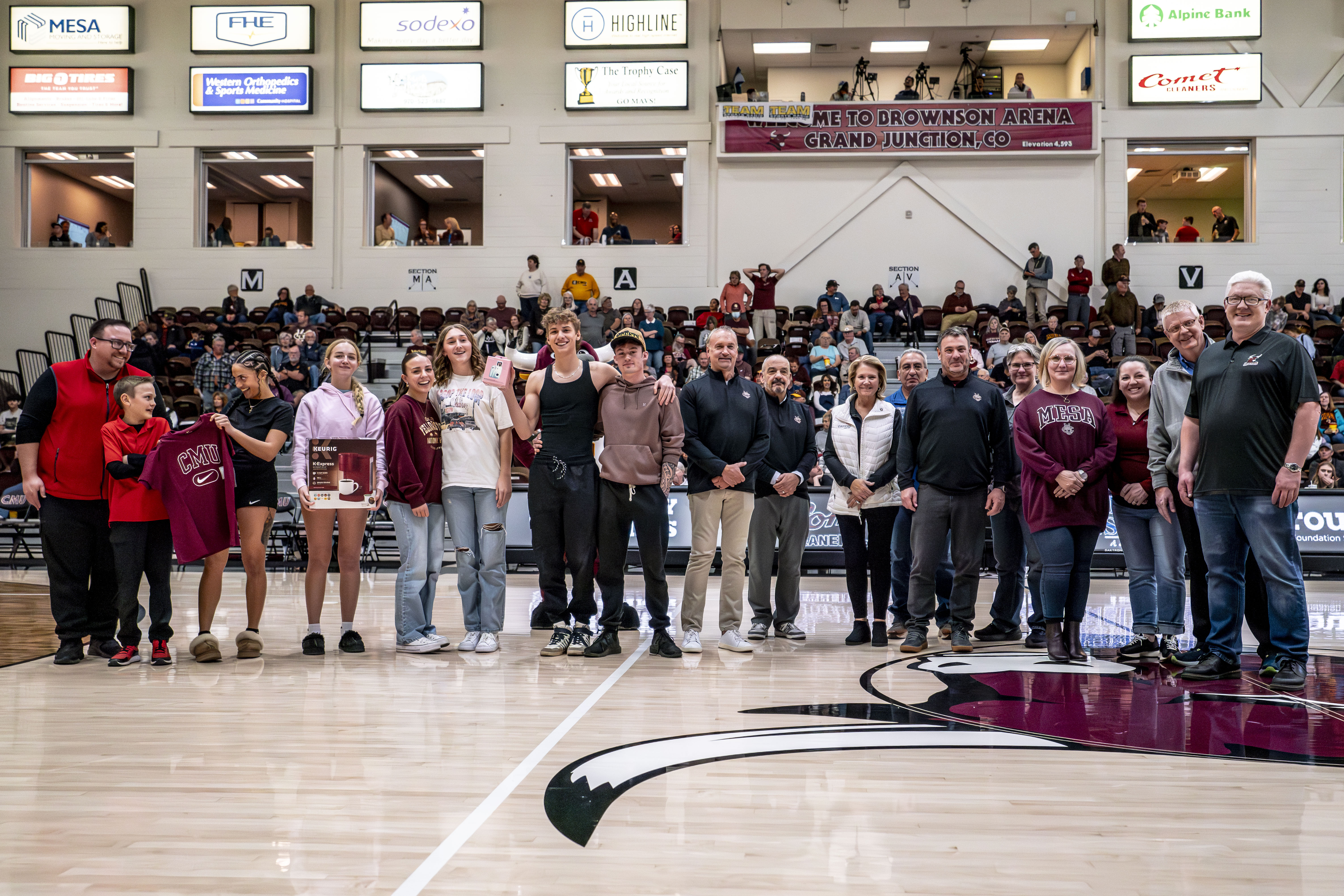 Canvas and CMU representatives on basketball court at halftime